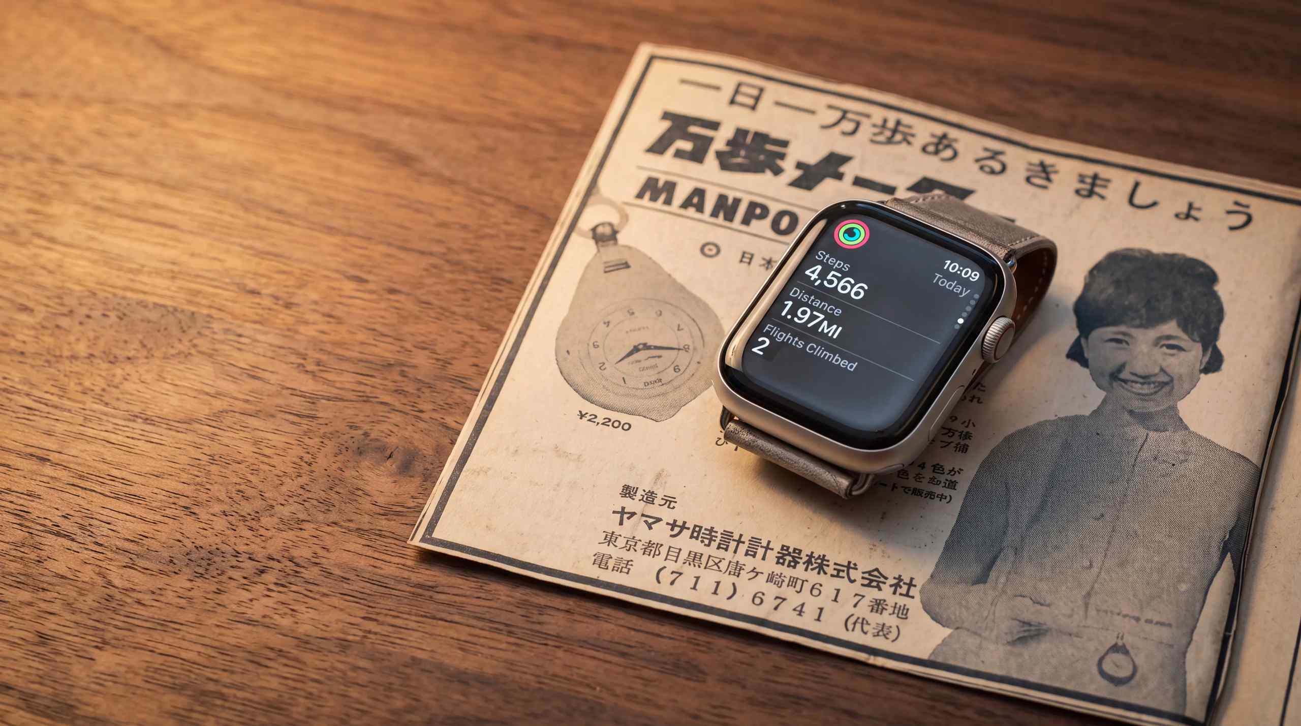 A smart watch sitting on a table with the Apple health dashboard tracking steps.